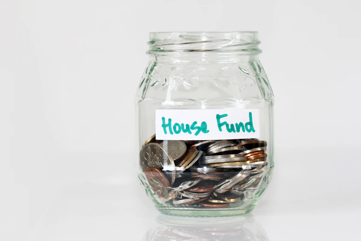 Coins stacked in a clear glass jar representing reset funds and trading capital